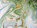Marbled blue, green and gold abstract background. Liquid marble pattern.