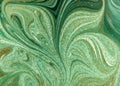 Marbled green abstract background with golden sequins. Liquid marble ink pattern. Royalty Free Stock Photo