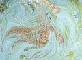 Marbled green abstract background with golden sequins. Liquid marble ink pattern.