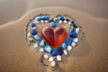 marbles creating a heart shape on a sandy beach Royalty Free Stock Photo