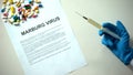Marburg virus diagnosis on paper, hand with syringe, pills and tablets on table Royalty Free Stock Photo
