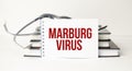 Marburg virus symbol. White note with words Marburg virus
