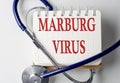 MARBURG VIRUS word on notebook with medical equipment on background Royalty Free Stock Photo