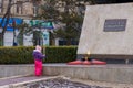 March 8, 2022 Balti, Moldova. Illustrative editorial. A girl lays flowers at the monument with eternal flame