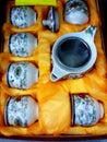 13 March 2020, Bangsar south, Kuala lumpur, Malaysia. A white tea set with colorful patterns in a yellow fabric box.
