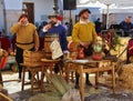 Men in medieval peasant costumes relax at the Spanish festival