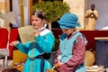 A girl and a boy dressed in carnival Arab costumes of the Middle Ages read at the carnival