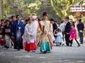 Bride and groom follow Shinto priests to Atsuta Shrine, Nagoya, Japan