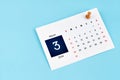 March 2024 calendar page with push pin on blue background Royalty Free Stock Photo