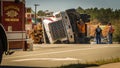 March 10, 2017:Carrboro, NC US-Man working on overturned logging truck