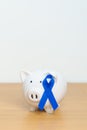 March Colorectal Cancer Awareness month, Navy Blue Ribbon with Piggy Bank for support illness life. Health, Donation, Charity, Royalty Free Stock Photo