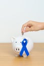 March Colorectal Cancer Awareness month, Navy Blue Ribbon with Piggy Bank for support illness life. Health, Donation, Charity, Royalty Free Stock Photo