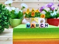 March. Colorful cube letters on sticky note block.