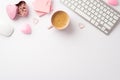 Top view photo of workstation keyboard pink sticky note paper heart shaped candles clips organizer and cup of frothy coffee Royalty Free Stock Photo