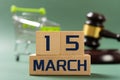 MARCH 15 in front and shopping cart & judge gavel on back concept of world consumer rights day Royalty Free Stock Photo