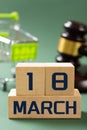MARCH 15 in front and shopping cart and judge gavel on back vertical composition concept of world consumer rights day Royalty Free Stock Photo