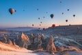 Goreme Cappadocia Turkey hot air balloons fly at pink sunrise over the sandstone mountains in the spring in the off-season