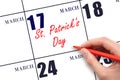 March 17. Hand writing text St. Patrick's Day on calendar date. Save the date. Royalty Free Stock Photo