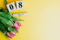 8 March Happy Women`s Day concept. With wooden block calendar and pink tulips on yellow background. Copy space Royalty Free Stock Photo