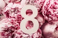 8 March. Happy Women`s Day. Creative layout. Pink peony flowers and digit eight 8. Birthday greeting card. Anniversary concept.