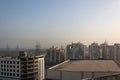 March 27, 2017 in India, wide shot of buildings under construction with bright sky at midday