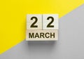 22 March inscription on yellow and gray background