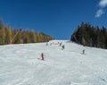 Skiers and snowboarders in mountains ski slopes of resort Les Arcs, France.