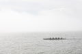 March 12, 2023 Lisbon, Portugal: Four people sailing on a canoe on a river on a foggy day Royalty Free Stock Photo