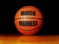 March Madness basketball on a hardwood court, college basketball tournament concept Royalty Free Stock Photo