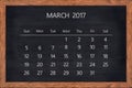 March month 2017 calendar on chalkboard wood frame.