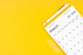 March 2024, Monthly desk calendar for 2024 year and pen with paper clips on yellow color background Royalty Free Stock Photo