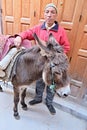 March 12, 2019 Morocco, Casablanca: A resident of the city with his harnessed donkey in a narrow bazaar street