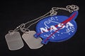 15 March 2018 - The National Aeronautics and Space Administration (NASA) emblem patch and dog tags Royalty Free Stock Photo