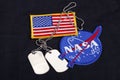 15 March 2018 - The National Aeronautics and Space Administration (NASA) emblem patch, dog tags, and US Flag patch on black Royalty Free Stock Photo