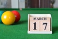 March 17, number cube with balls on snooker table, sport background.