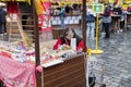 MARCH 25, 2016: An older lady selling decorated eggs in her wooden booth at the Easter markets on Old Towns Square, Prague