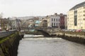 Parliament Bridge and the narrow streets of Cork Ireland on the Father Mathew Quay alongside the River Lee that runs through the c Royalty Free Stock Photo