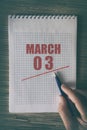 march 3rd. Day 3 of month, Close up of human hand with pen on notepad with red underlined date.  spring month, day of the year Royalty Free Stock Photo