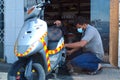 2 march 2021,riyadh Saudi Arabia,An Indian motor bike mechanic at work with safety mask,