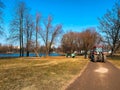 March, Saint- Petersburg, Russia. Red tractors trucks in spring city park Cleaning. Early spring Works. Sunny spring day Royalty Free Stock Photo