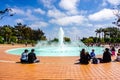 March 19, 2019 San Diego / CA / USA - People sitting around a waterfall in Balboa Park Royalty Free Stock Photo