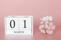 March 01st. Day 1 of month. Calendar cube on modern pink background, concept of bussines and an importent event