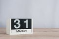 March 31st. Day 31 of month, wooden calendar on light background. Spring time, empty space for text