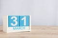 March 31st. Day 31 of month, wooden color calendar on table background. Spring time, empty space for text Royalty Free Stock Photo