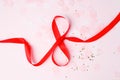 8 March symbol. Figure of eight made of red satin ribbon. Happy womans day design. Decorative greeting holiday card or postcard