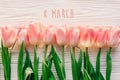 8 march text on pink tulips on white rustic wooden background. g Royalty Free Stock Photo