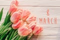 8 march text on pink tulips on white rustic wooden background. g Royalty Free Stock Photo