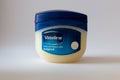 A vaseline cream container against a white background