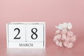 March 28th. Day 28 of month. Calendar cube on modern pink background, concept of bussines and an importent event