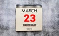 march 23. 23th day of month, calendar date. Stand for desktop calendar on beige wooden background